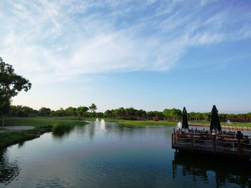 a group of people sitting on a boat on a river at Sueno Hotels Deluxe Belek in Belek