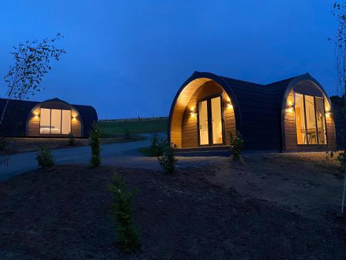 a home with two domed buildings at night at The Vu Snugs in Bathgate