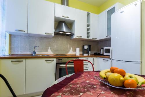 a bowl of fruit on a table in a kitchen at Quattro Cantoni Apartments in Zadar