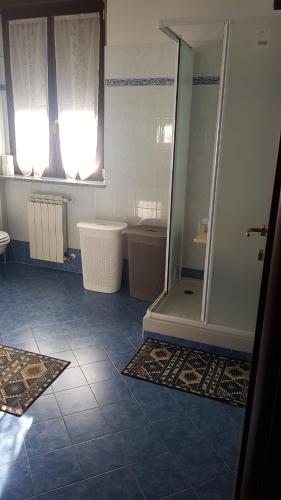 a bathroom with a shower and a tub and a sink at Iris in Cislago