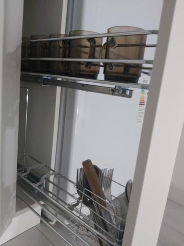 an open dishwasher with dishes and utensils in it at 2-х комнатная квартира in Taraz