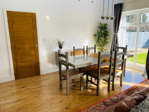 a dining room with a table and chairs at Mayors House Ideal for Groups & Business in Peterborough