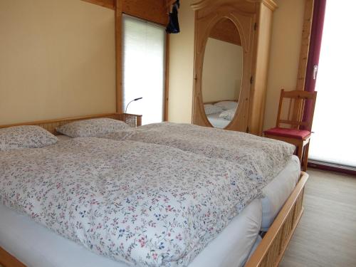 a bedroom with a bed and a large mirror at Blaues Haus - Une maison bleue in Hetzerath