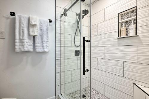 a shower with a glass door in a bathroom at Colorful Condo in Pagosa Springs with Patio! in Pagosa Springs