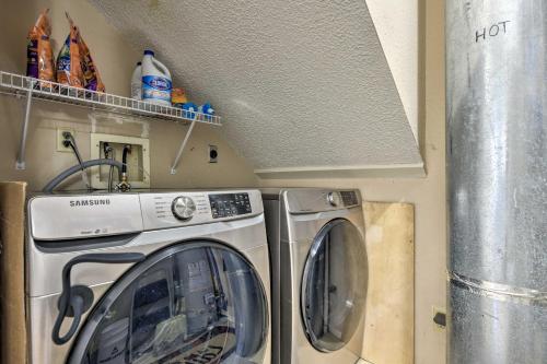 a washing machine and a washer in a room at Colorful Condo in Pagosa Springs with Patio! in Pagosa Springs