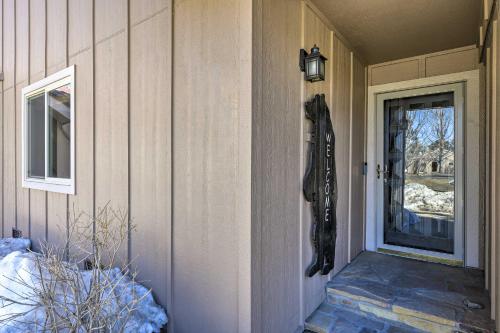 a front door of a house with a horse head on the wall at Colorful Condo in Pagosa Springs with Patio! in Pagosa Springs