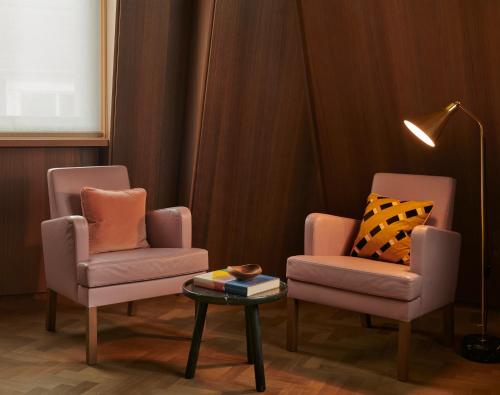 two chairs and a coffee table in a room at Hotel Cafe Royal in London