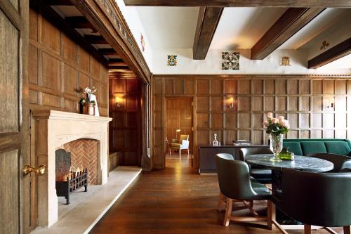a dining room with a fireplace and a table and chairs at Hotel Cafe Royal in London