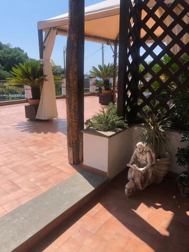 a statue of a man sitting on a patio at Donna Caterì in Termini