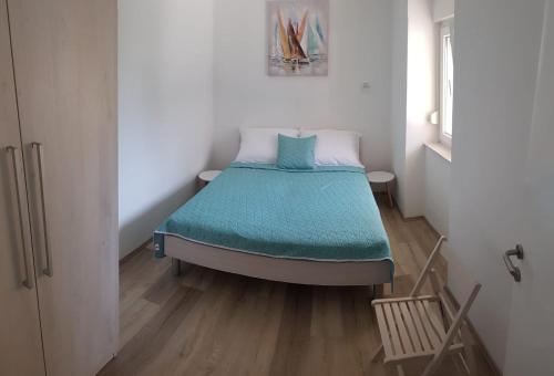 a small bedroom with a bed in a room at Apartman Milo - Zadar in Zadar
