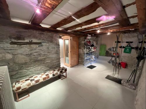 a room with a stone wall with a bench in it at Chalet / Maison Bourgeoise entièrement rénovée in Vignec