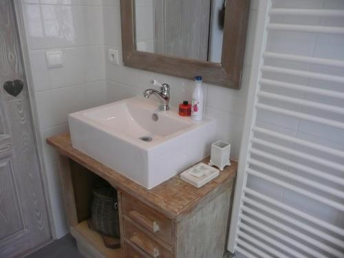 a bathroom with a white sink and a mirror at Ecole de Mathuna de Marigny Brizay in Marigny-Brizay