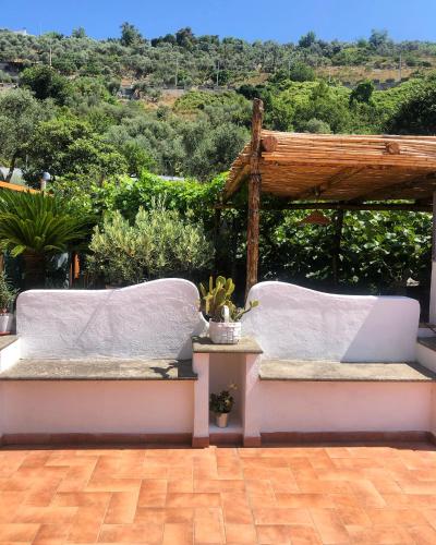 two white cushioned benches sitting on a patio at Donna Caterì in Termini