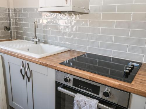 a kitchen with a sink and a stove at Old Peak in Scarborough