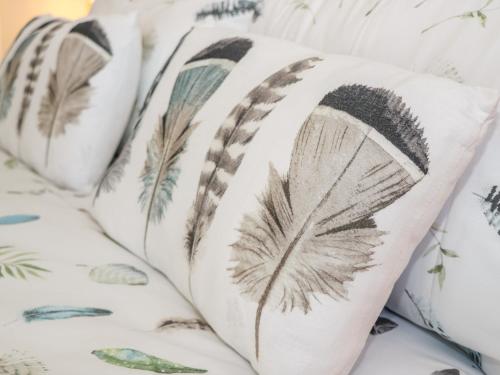 a group of pillows with feather patterns on them at Old Peak in Scarborough