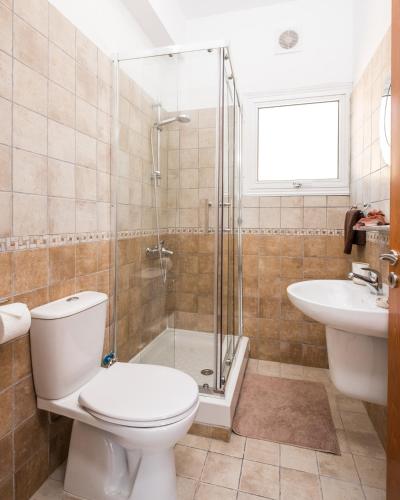 a bathroom with a toilet and a shower and a sink at Voroklini Villa with Pool in Larnaca