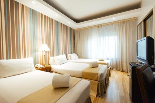 Voodi või voodid majutusasutuse Dorá Hotel Buenos Aires toas