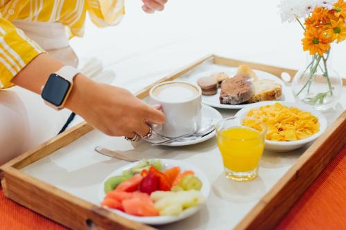 布宜诺斯艾利斯Dorá Hotel Buenos Aires的桌上的早餐食品和饮料托盘