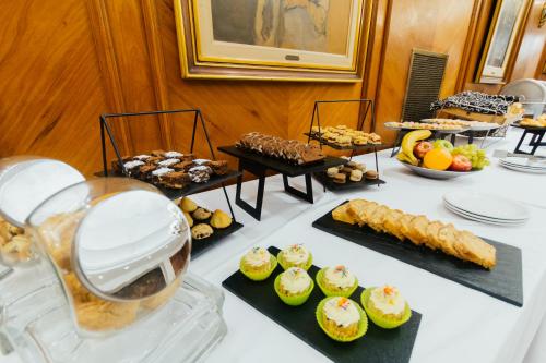 布宜诺斯艾利斯Dorá Hotel Buenos Aires的餐桌上摆放着各种糕点和甜点