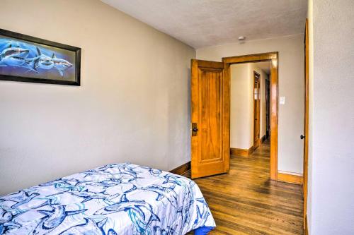 a bedroom with a bed and a wooden door at White House of Red Wing with Wii Video Game! in Red Wing