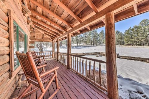 a porch of a cabin with two rocking chairs at Cozy Alto Cabin on 2 Acres Near Fishing and Skiing! in Alto