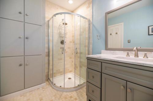 a bathroom with a shower and a sink at Waterfront Edenton Bay Cottage - Walk to Dtwn in Edenton