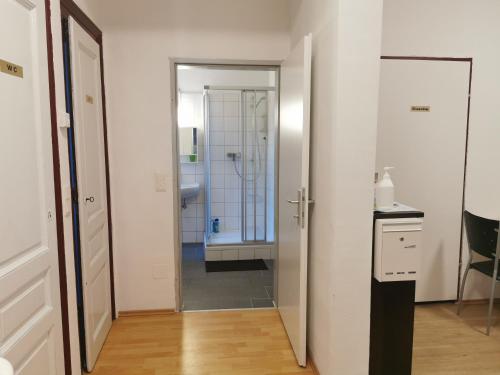 a bathroom with a walk in shower and a sink at 7brunnen Hostel Beds & Rooms in Vienna