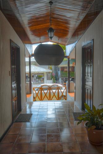 a hallway with a large light hanging from a ceiling at Hotel El Jardin in Montezuma