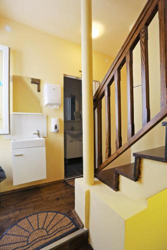 a room with a staircase with a refrigerator and a kitchen at Tequila Bar Hostel in Zadar