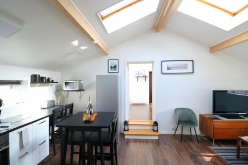 a kitchen and dining room with skylights at Bright & Spacious Apartment in Kinna Center in Kinna