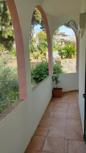 a hallway with two arched windows in a house at Hotel Villino Gallodoro in Taormina