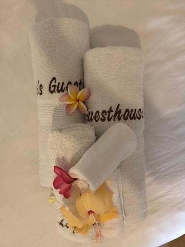 a group of towels with flowers on a table at Frangipani garden villa in Senggigi 