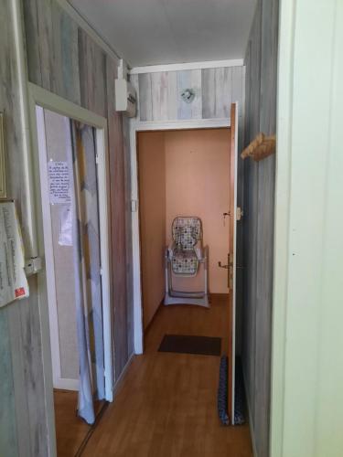 a hallway with a chair in a room at GITE DE L ASPRE in Fontanges