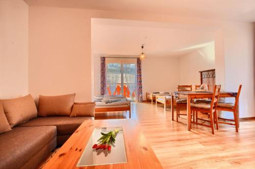 a living room with a couch and a table at Apartamenty Soszów in Wisła