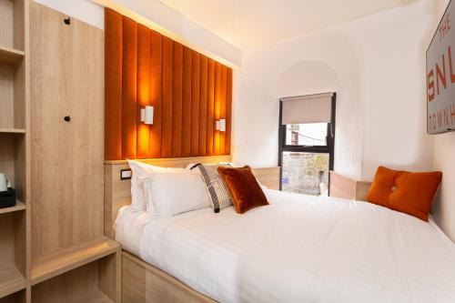 a bedroom with a large white bed in a room at The Snug Townhouse in Galway