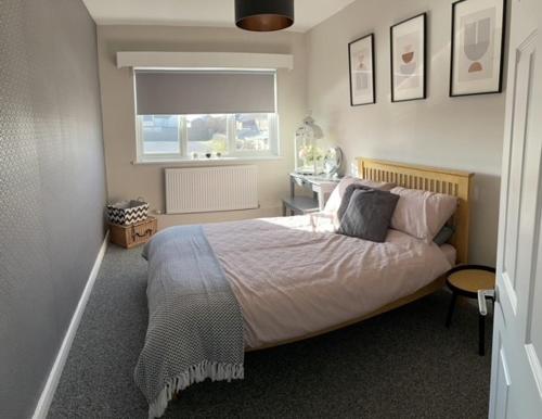 a bedroom with a bed and a window and a window at 3 bedroom modern flat, sleeps 8, Mablethorpe, Linc in Mablethorpe