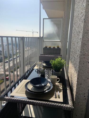 a table with plates of food on a balcony at SanthooftB 0905 in Nieuwpoort