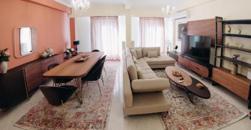 a living room with a dining table and a living room with a television at Best House, Psila Alonia Square Luxury, Patra in Patra