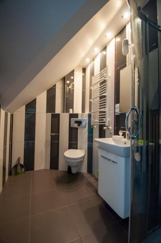 a bathroom with a toilet and a sink at Noclegi Pobierowo NATALIA - przy morzu in Pobierowo