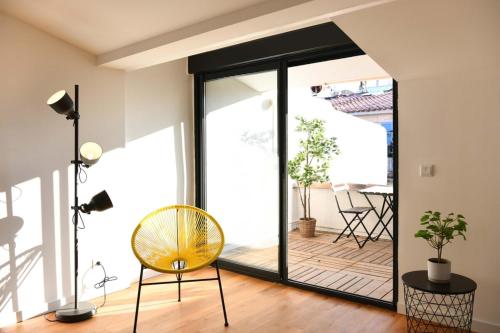 Cette chambre dispose d'une porte en verre donnant sur une terrasse. dans l'établissement Le Duplex - Terrasse au cœur de Marseille Panier, à Marseille