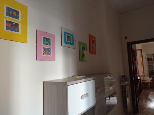 a room with a cabinet and some pictures on the wall at CASA VACANZE "A casa di Maria" in Naples