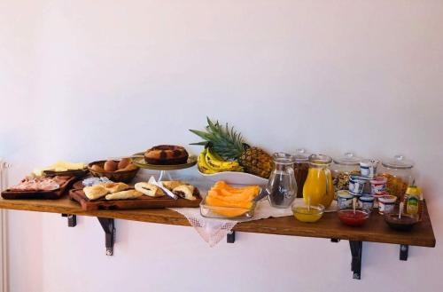 a table with a bunch of different types of food on it at B&B Le Ginestre in Cefalù