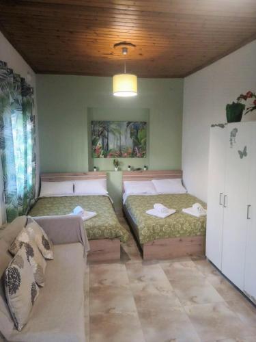 a room with two beds and a couch in it at City Hall House in Volos