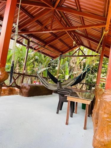 a couple of hammocks hanging from a roof at Aunty Arenal Lodge in Fortuna