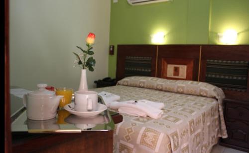 a bedroom with a bed and a table with a tea set at Tradición de Salta in Salta