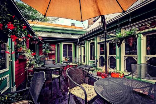 an outdoor patio with tables and chairs and an umbrella at Auberge J.A Moisan in Quebec City