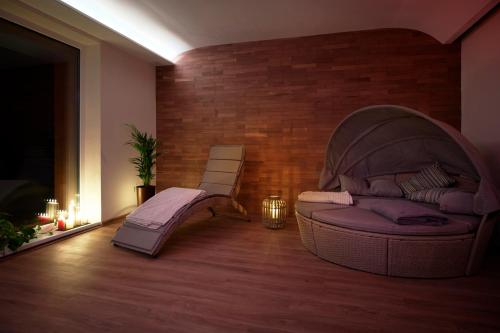 a living room with a couch and a chair at Hotel Kochau in Kováčová