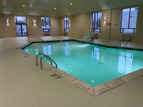 a large swimming pool with blue water in a building at Quality Inn & Suites University-Airport in Louisville