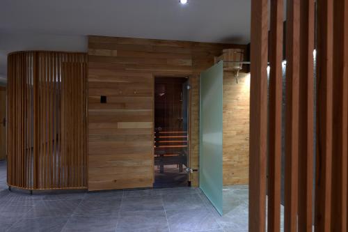 a hallway with a wooden wall and a door at Hotel Kochau in Kováčová