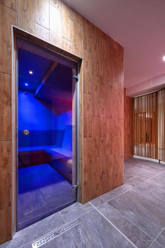 an open door to a room with blue lights at Hotel Kochau in Kováčová